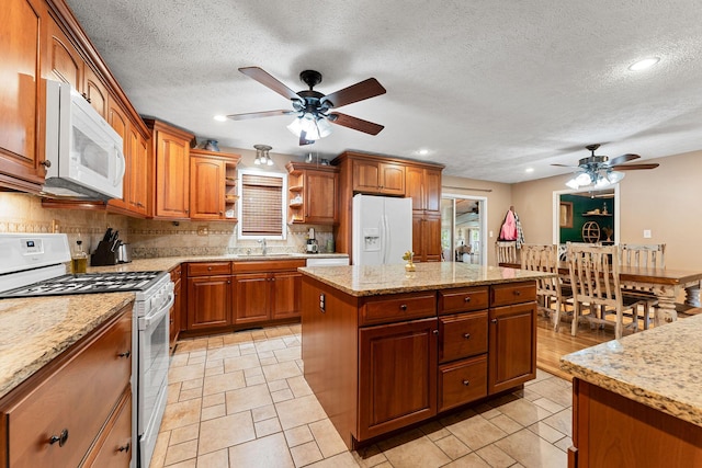 19326 Boat Dock Rd W, Omaha, AR 72662 - kitchen featuring white appliances, ceiling fan, open shelves, backsplash, and brown cabinetry