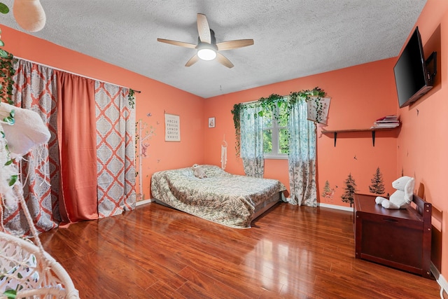19326 Boat Dock Rd W, Omaha, AR 72662 - bedroom featuring wood finished floors, a textured ceiling, baseboards, and a ceiling fan