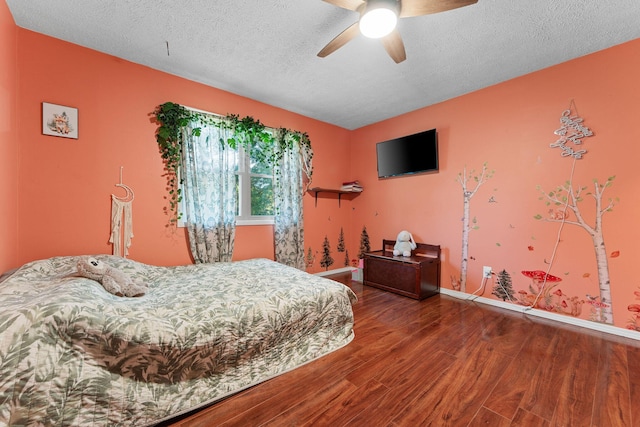 19326 Boat Dock Rd W, Omaha, AR 72662 - bedroom with wood finished floors, baseboards, a textured ceiling, and a ceiling fan