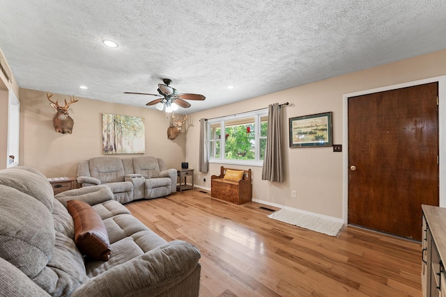 19326 Boat Dock Rd W, Omaha, AR 72662 - living room with light wood-style floors, a ceiling fan, baseboards, a textured ceiling, and recessed lighting