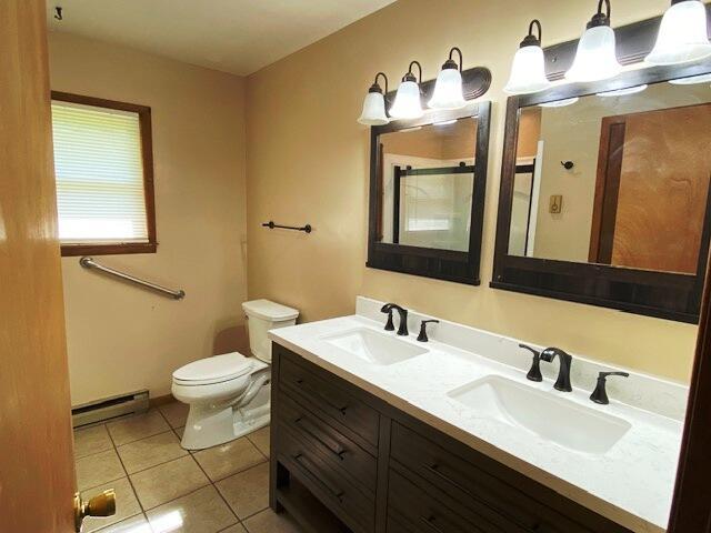 1208 Oak Ridge Dr, Aurora, MO 65605 - bathroom with a baseboard radiator, toilet, tile patterned flooring, and double vanity