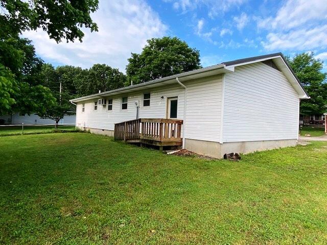 1208 Oak Ridge Dr, Aurora, MO 65605 - rear view of house with a yard and a wooden deck