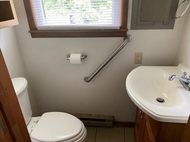 1208 Oak Ridge Dr, Aurora, MO 65605 - half bath with electric panel, vanity, and tile patterned flooring