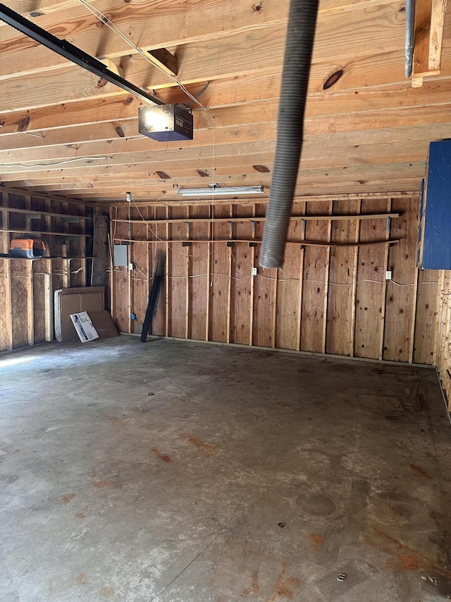 130 Wichita Ave, Forsyth, MO 65653 - garage featuring a garage door opener and wooden walls
