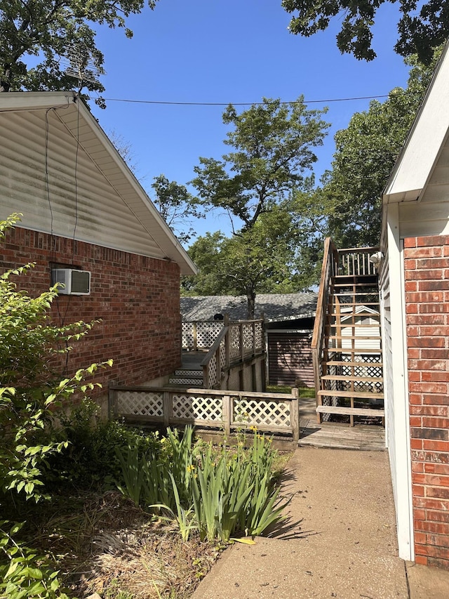 130 Wichita Ave, Forsyth, MO 65653 - view of property exterior with stairs and brick siding