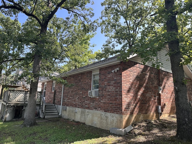 130 Wichita Ave, Forsyth, MO 65653 - view of property exterior featuring brick siding, a deck, and cooling unit