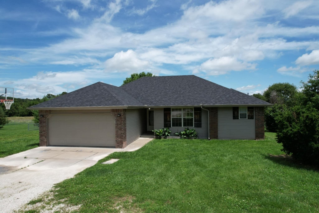 234 Stonefield Rd, Clever, MO 65631 - ranch-style home with a garage, brick siding, and a front lawn