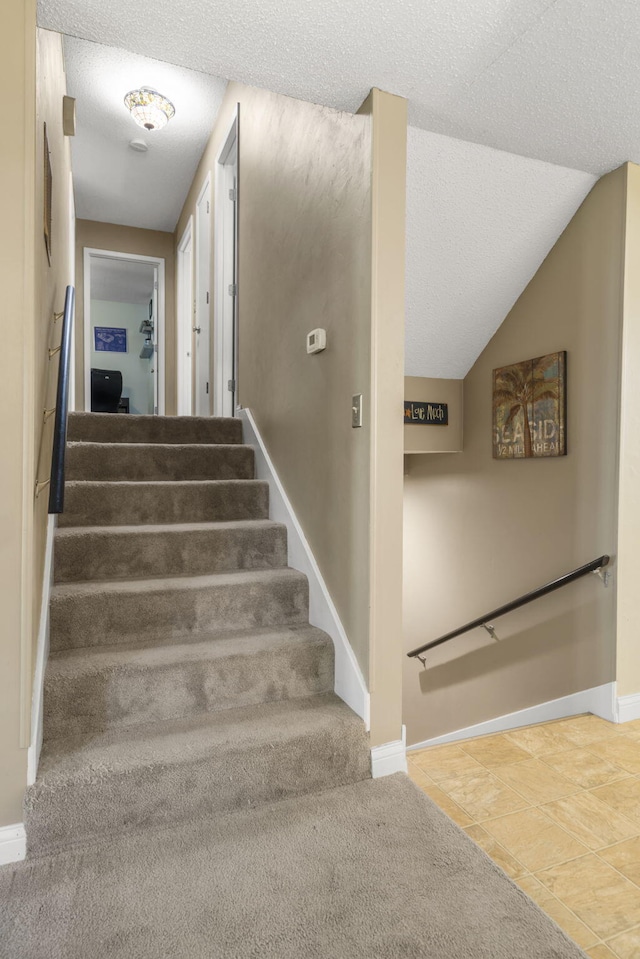 5527 S Honeysuckle Ln, Battlefield, MO 65619 - stairway featuring baseboards and a textured ceiling