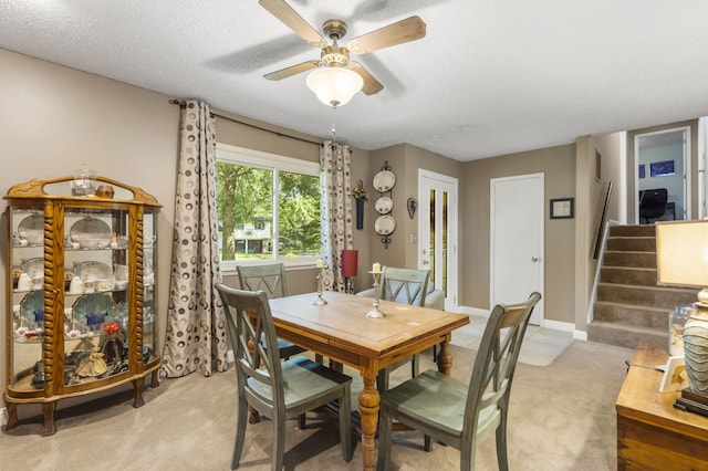 5527 S Honeysuckle Ln, Battlefield, MO 65619 - dining room with light colored carpet, a ceiling fan, stairway, and a textured ceiling