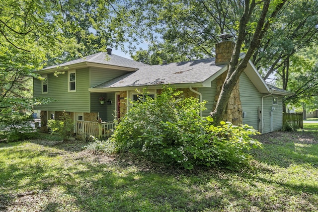5527 S Honeysuckle Ln, Battlefield, MO 65619 - view of front of house with a chimney, a front yard, roof with shingles, and a wooden deck