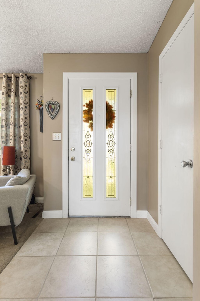 5527 S Honeysuckle Ln, Battlefield, MO 65619 - doorway featuring a textured ceiling, light tile patterned floors, and baseboards