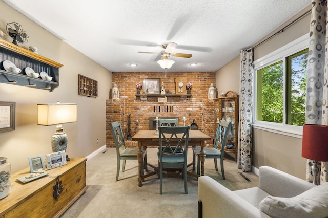 5527 S Honeysuckle Ln, Battlefield, MO 65619 - dining space featuring a ceiling fan, light carpet, brick wall, a textured ceiling, and baseboards