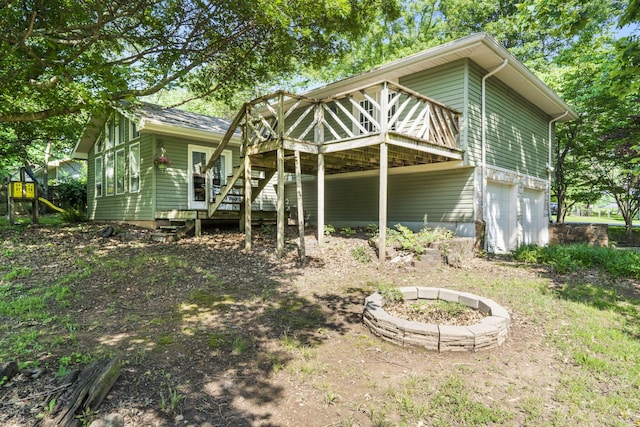 5527 S Honeysuckle Ln, Battlefield, MO 65619 - back of house with a wooden deck, stairway, and a fire pit