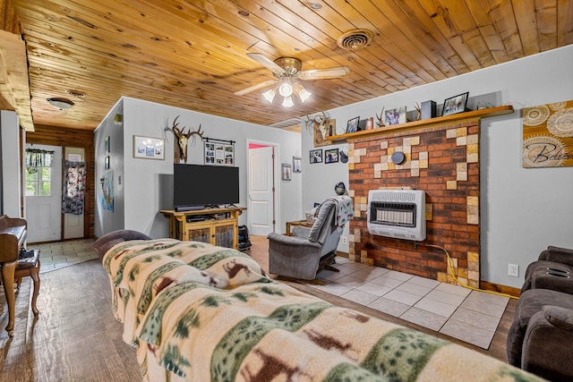 206 Plum St, Sparta, MO 65753 - living room with heating unit, wooden ceiling, ceiling fan, baseboards, and tile patterned flooring