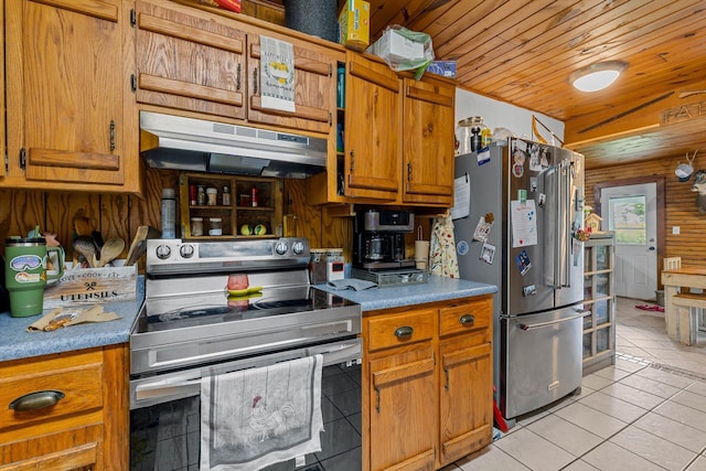 206 Plum St, Sparta, MO 65753 - kitchen with appliances with stainless steel finishes, under cabinet range hood, light tile patterned flooring, wood ceiling, and brown cabinetry