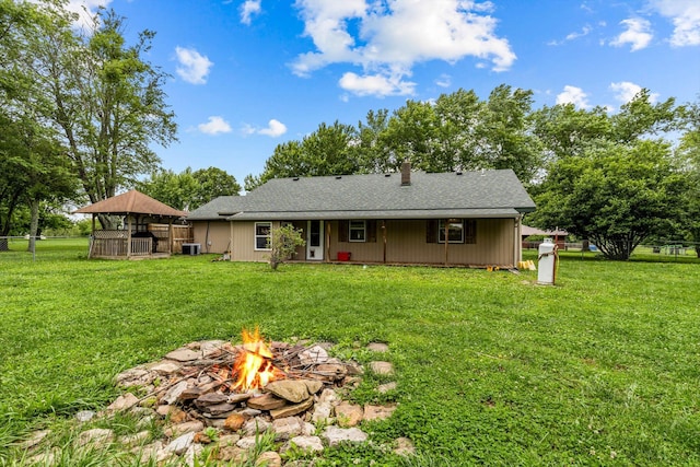 206 Plum St, Sparta, MO 65753 - rear view of house featuring an outdoor fire pit, central AC, roof with shingles, and a gazebo