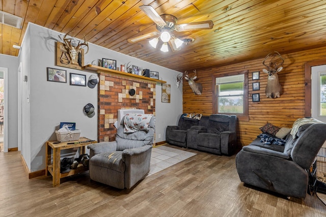 206 Plum St, Sparta, MO 65753 - living room featuring wood ceiling, light wood-type flooring, ceiling fan, and wood walls