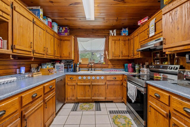 206 Plum St, Sparta, MO 65753 - kitchen featuring appliances with stainless steel finishes, a sink, under cabinet range hood, light tile patterned flooring, and brown cabinets