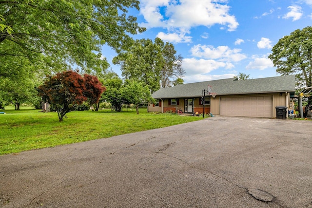 206 Plum St, Sparta, MO 65753 - view of front facade featuring asphalt driveway, an attached garage, a front yard, and roof with shingles