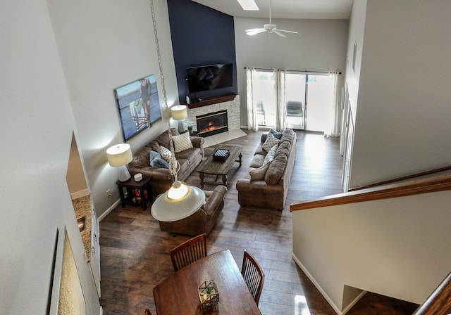 280 Wimbledon Dr Unit 9, Branson, MO 65616 - living area with a stone fireplace, high vaulted ceiling, a ceiling fan, wood-type flooring, and baseboards