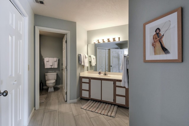 280 Wimbledon Dr Unit 9, Branson, MO 65616 - bathroom with toilet, vanity, and baseboards