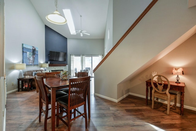 280 Wimbledon Dr Unit 9, Branson, MO 65616 - dining space featuring high vaulted ceiling, a fireplace, wood finished floors, baseboards, and a skylight