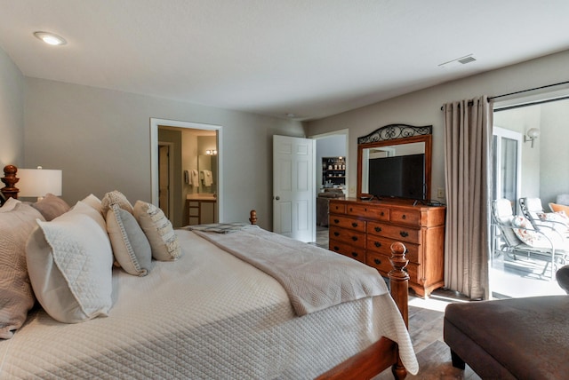 280 Wimbledon Dr Unit 9, Branson, MO 65616 - bedroom with wood finished floors, ensuite bathroom, and access to exterior