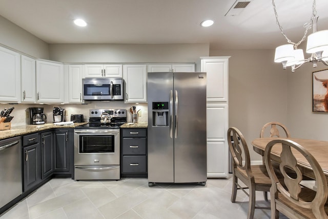 280 Wimbledon Dr Unit 9, Branson, MO 65616 - kitchen featuring appliances with stainless steel finishes, white cabinets, a chandelier, light stone counters, and recessed lighting