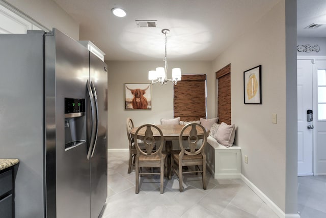 280 Wimbledon Dr Unit 9, Branson, MO 65616 - dining area with a chandelier, baseboards, and light tile patterned floors