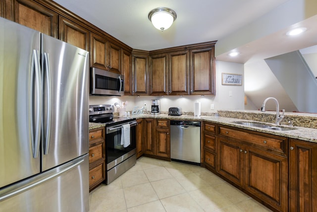 318 Wimbledon Dr Unit 8, Branson, MO 65616 - kitchen featuring appliances with stainless steel finishes, a sink, light stone counters, light tile patterned floors, and recessed lighting