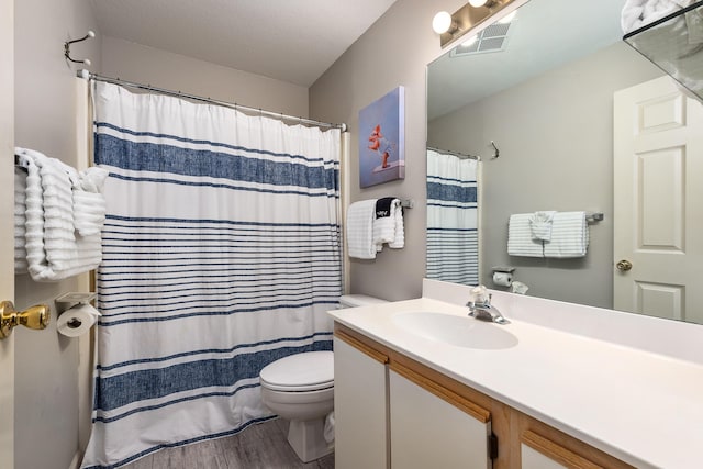344 Wimbledon Dr Unit 7, Branson, MO 65616 - bathroom featuring vanity, toilet, wood finished floors, and a shower with curtain
