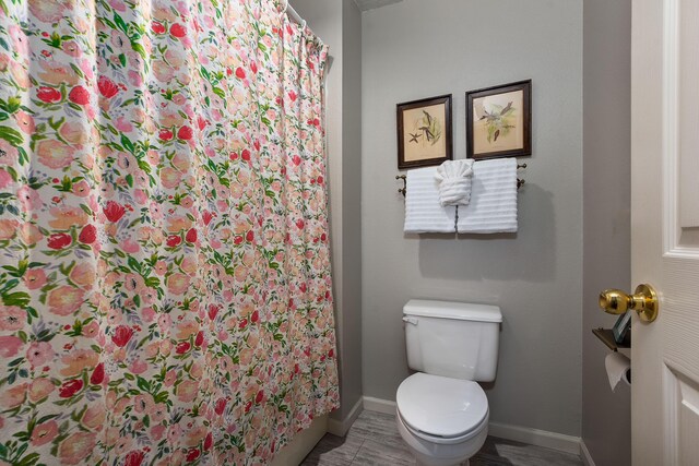 344 Wimbledon Dr Unit 7, Branson, MO 65616 - bathroom featuring toilet, baseboards, and a shower with curtain