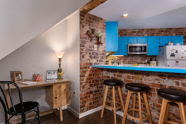 344 Wimbledon Dr Unit 7, Branson, MO 65616 - bar with freestanding refrigerator, stainless steel microwave, wood finished floors, and baseboards