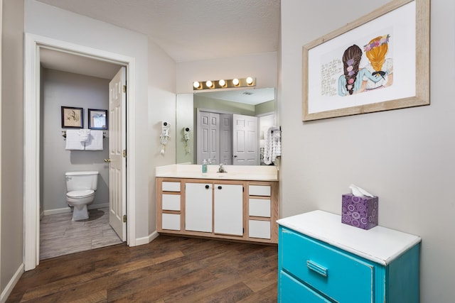 344 Wimbledon Dr Unit 7, Branson, MO 65616 - bathroom featuring wood finished floors, vanity, toilet, and baseboards