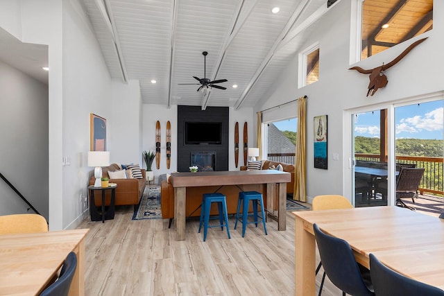 224 David Shawn Dr, Branson, MO 65616 - living room with a ceiling fan, light wood finished floors, a fireplace, a high ceiling, and wood ceiling with exposed beams
