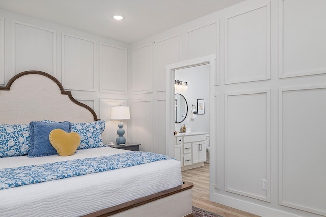 224 David Shawn Dr, Branson, MO 65616 - bedroom with a decorative wall, light wood-style floors, and recessed lighting
