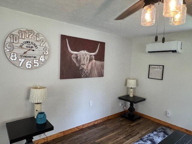 83 Dawn Cir, Galena, MO 65656 - dining room with a wall mounted AC, wood finished floors, a ceiling fan, and a textured ceiling