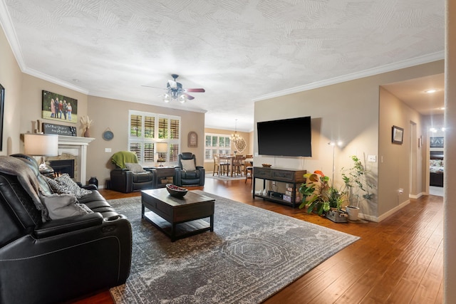 1002 S Joshua Ave, Republic, MO 65738 - living room featuring ceiling fan, wood-type flooring, a warm lit fireplace, baseboards, and ornamental molding