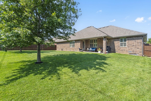 1002 S Joshua Ave, Republic, MO 65738 - back of property with brick siding, a patio area, and a shingled roof