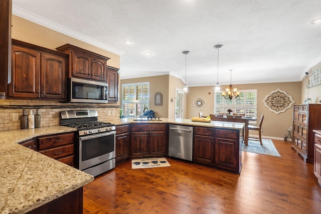 1002 S Joshua Ave, Republic, MO 65738 - kitchen with stainless steel appliances, a sink, ornamental molding, a peninsula, and healthy amount of natural light