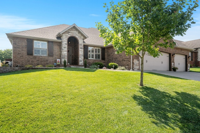 1002 S Joshua Ave, Republic, MO 65738 - view of front of home with brick siding, driveway, a garage, and a front yard