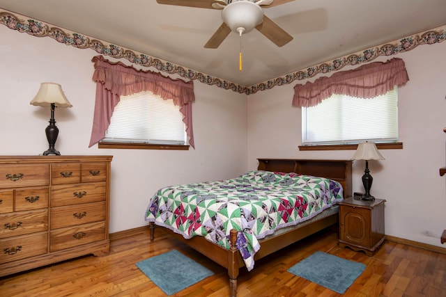2812 W Lombard St, Springfield, MO 65802 - bedroom with multiple windows, light wood finished floors, ceiling fan, and baseboards