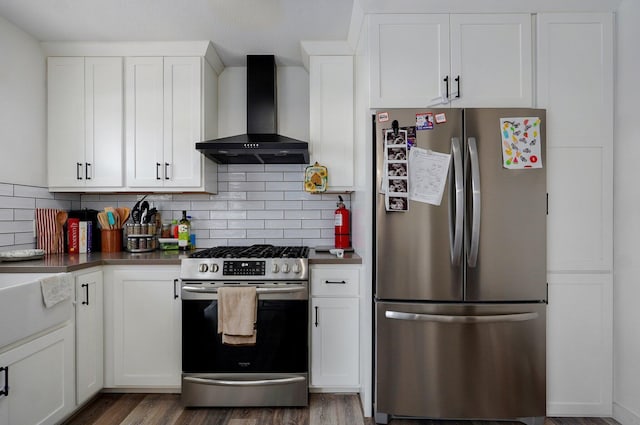 803 W Ridgecrest St, Ozark, MO 65721 - kitchen featuring appliances with stainless steel finishes, wall chimney range hood, dark wood finished floors, white cabinets, and tasteful backsplash