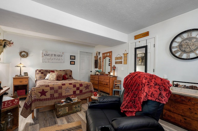 803 W Ridgecrest St, Ozark, MO 65721 - bedroom with wood finished floors and a textured ceiling