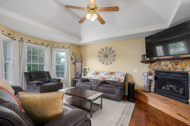 803 W Ridgecrest St, Ozark, MO 65721 - living room with wood finished floors, a stone fireplace, a ceiling fan, a tray ceiling, and lofted ceiling