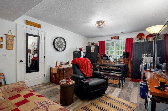 803 W Ridgecrest St, Ozark, MO 65721 - living room featuring wood finished floors and a textured ceiling