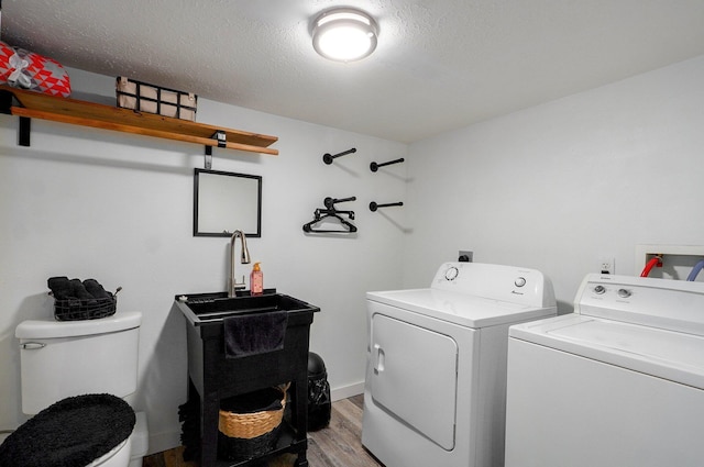 803 W Ridgecrest St, Ozark, MO 65721 - washroom featuring independent washer and dryer, light wood finished floors, and a textured ceiling
