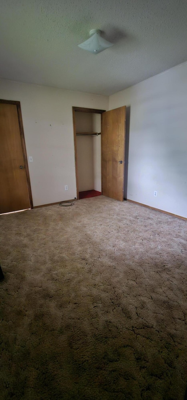 2211 Joanne- Dr, West Plains, MO 65775 - unfurnished bedroom with carpet floors, a textured ceiling, a closet, and baseboards