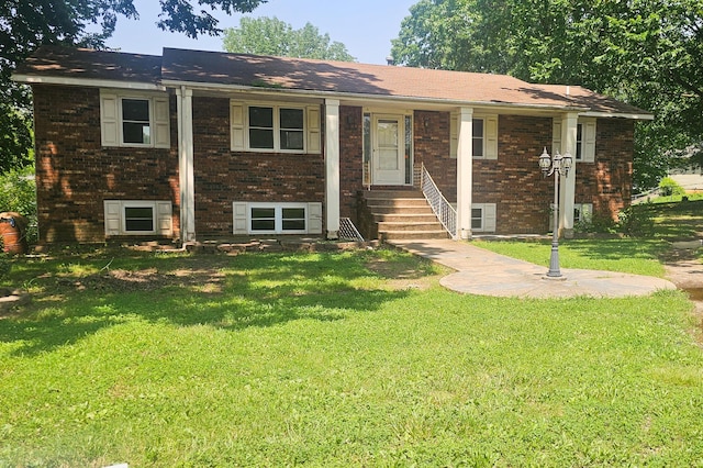 2211 Joanne- Dr, West Plains, MO 65775 - view of front of home with brick siding, a front yard, and entry steps