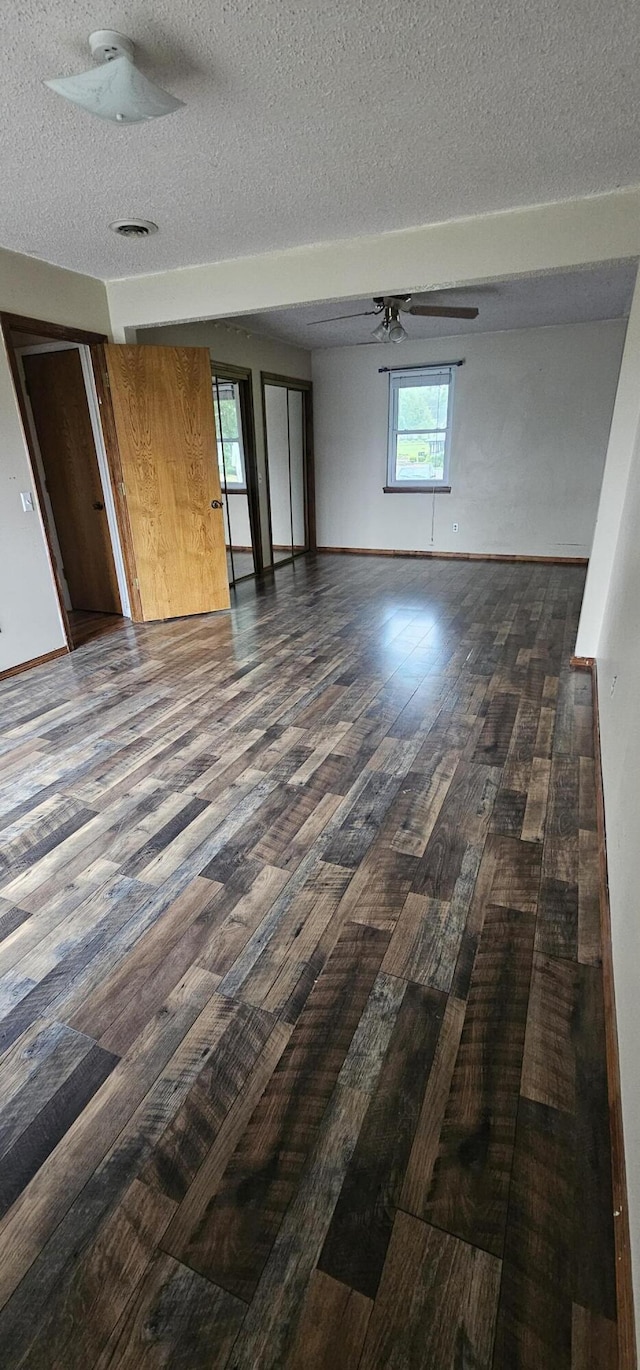 2211 Joanne- Dr, West Plains, MO 65775 - empty room featuring dark wood-type flooring, a textured ceiling, baseboards, and ceiling fan